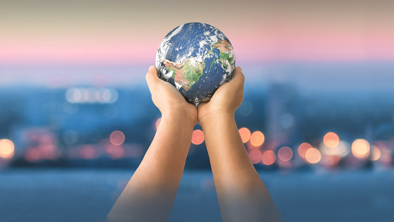 Hands holding up a small globe: corporate responsibility at Hayward Tyler