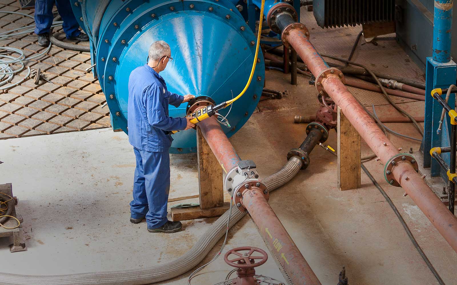 Man testing large industrial pump at customer facility - Hayward Tyler