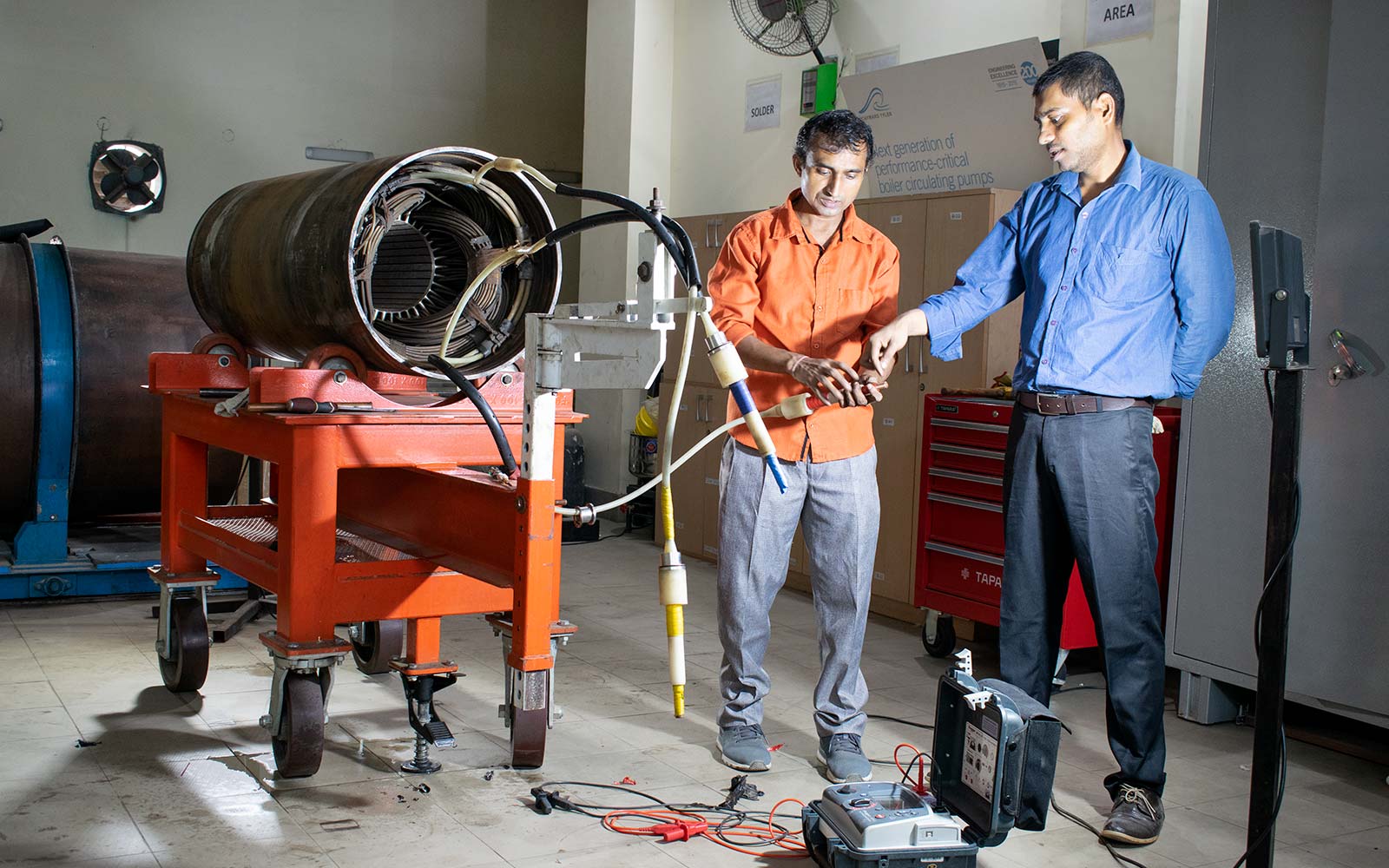 Two men working in Hayward Tyler rewind facility in Delhi, India