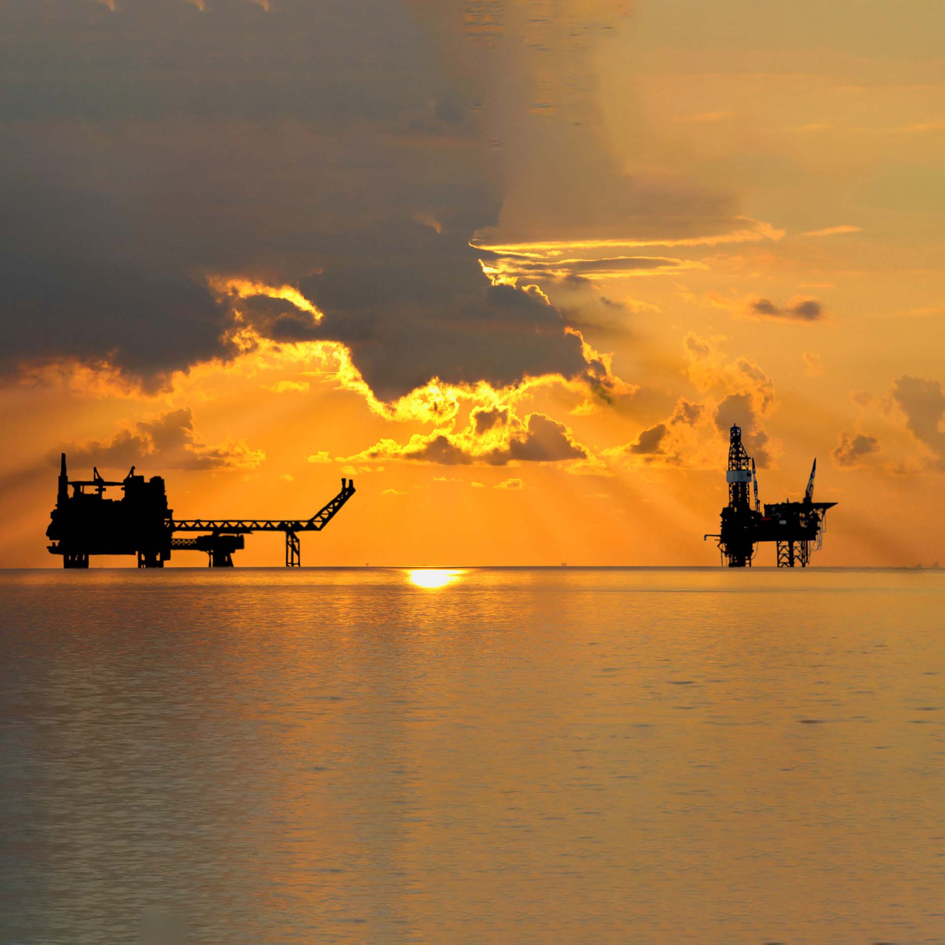 oil rigs with orange sunset